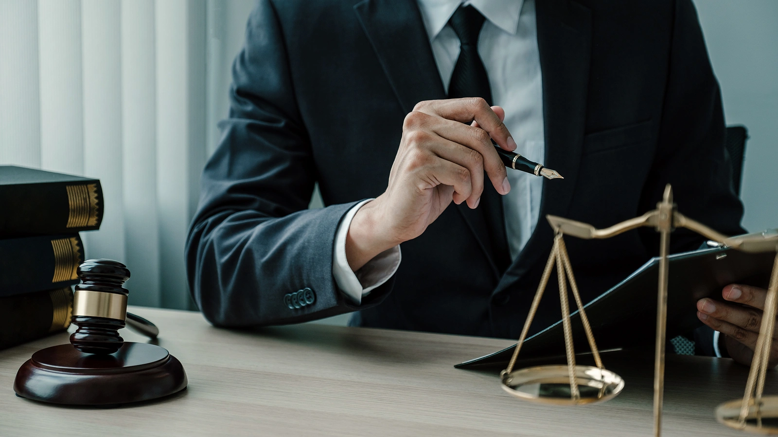 Lawyer in a suit at a desk with a gavel, law books and scales of justice, representing law firm AI visibility checks