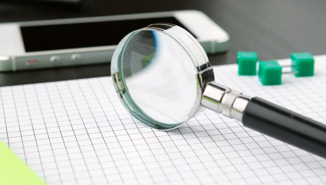 Magnifying glass checking AI answers for Legal 500 errors